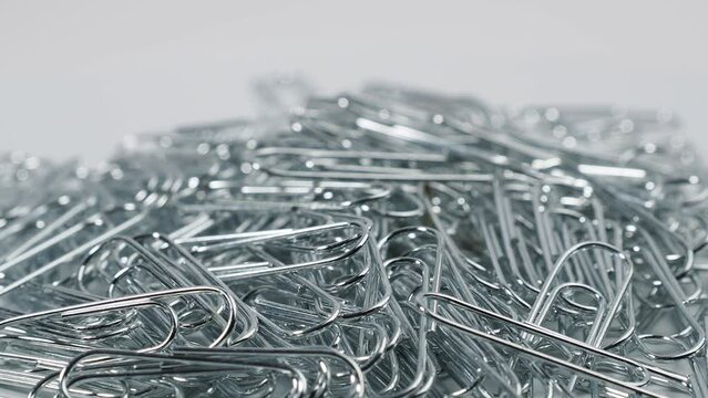 Metal rotating paper clips. Paper clips close up.