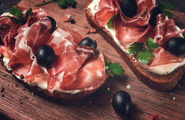 sandwich with cream cheese, prosciutto with olives , breakfast,