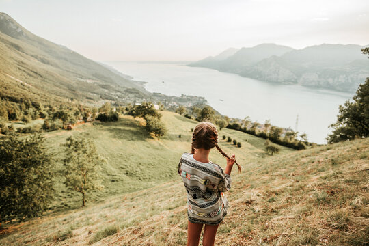 Rear view of a girl with pigtails on a hill at Lake Garda in Italy