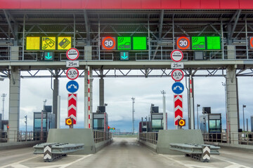 View gate for cars at the entrance to the toll road, limited by the barrier. Cashless payment...