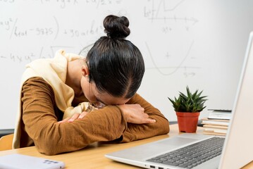 Tired exhausted Indian woman falling asleep at desk close up, sitting at table with laptop, lack of sleep and insomnia concept, overworked unmotivated girl lying on table, feeling boredom