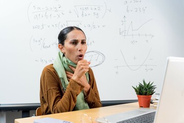 Arabian female teacher work in classroom during ill. Prepare for exam while coronavirus pandemic....