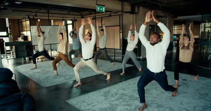 The international team does yoga during the break between work in the office. Oyise workers keep their body and mind in fine