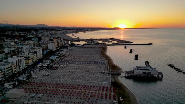 4k aerial footage of the beautiful Gabicce Mare at sunset with the entire Romagna Riviera from Cattolica, Misano, Riccione to Rimini