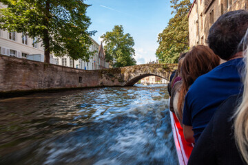Tourists on a sight seeing boat trip in Bruges Belgium on the Brugge Zeebrugge Canal - 633099860