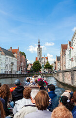 Naklejka premium Tourists on a sight seeing boat trip on the Brugge Zeebrugge Canal