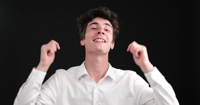 Caucasian blogger as he delivers an message on a captivating black background. With genuine enthusiasm, he engages his viewers, encouraging them to hit the like button and subscribe to his channel.