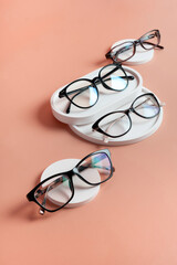 Podiums with eyeglasses on colored background. Optical store, vision test, stylish glasses concept...