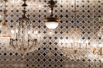 chandeliers arranged in a row on a reflective background used as decoration for events