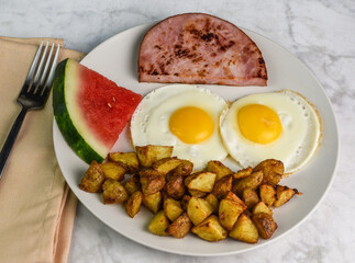 fried eggs  with ham homefries and water melon