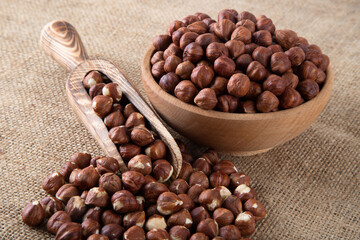 View of a bowl full of peeled hazelnut on burlap sack
