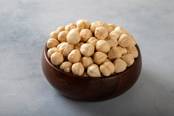 View of a bowl full of hazelnuts on a bright background,closeup