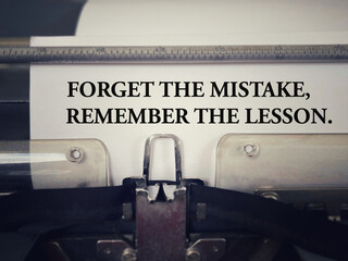 Motivational and inspirational wording. Forget The Mistake, Remember The Lesson. With blurred...