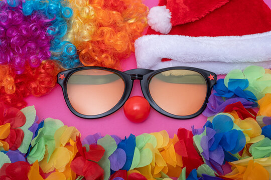 Funny Party set concept sunglasses and a Santa hat, wreath, artificial Hawaiian lei, red clown nose. Cosplay Festive Background