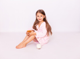 . Health & Beauty. Little  girl having breakfast, drinking milk. Adorable little girl with towel on the head  biting a croissant and drinking milk on the morning. Paris. Bonjour © Alla