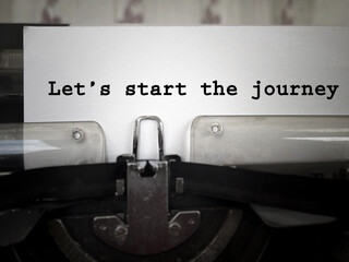 Motivational and inspirational wording. Let’s Start The Journey written on white paper. With...
