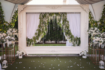 Wedding arch decorated with cloth and flowers outdoors. Beautiful wedding set up. Wedding ceremony...