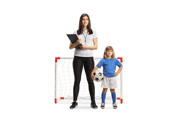 Fototapeta premium Female PE teacher standing in front of a mini goal with a little girl