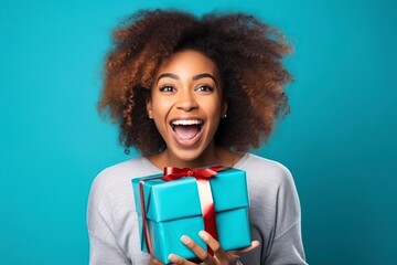 young black woman with a gift package posing in the studio