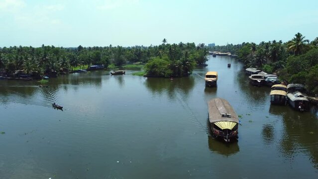 Aerial view of traditional houseboat cruising Kerala backwaters. Travel India