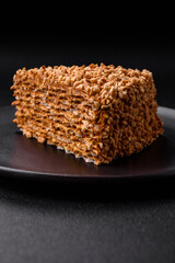 Delicious sweet puff waffle cake with cream and nuts cut into pieces