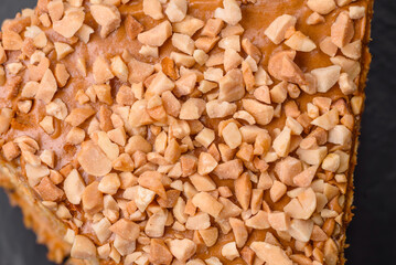 Delicious sweet puff waffle cake with cream and nuts cut into pieces