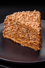 Delicious sweet puff waffle cake with cream and nuts cut into pieces