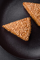 Delicious sweet puff waffle cake with cream and nuts cut into pieces