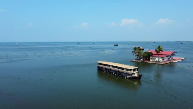 Aerial view of traditional houseboat cruising Kerala backwaters. Travel India