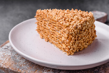 Delicious sweet puff waffle cake with cream and nuts cut into pieces