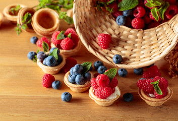 Small tartlets with fresh raspberries and blueberries.