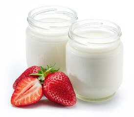 Two jars of homemade organic yoghurt and fresh strawberries near them on white background.