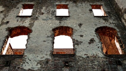 Broken wall, with sunlight streaming through the open windows