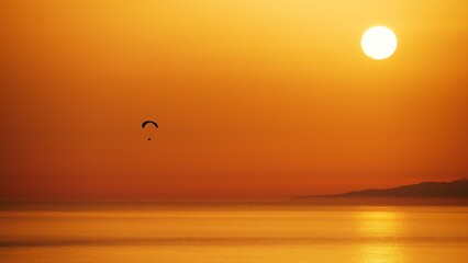 Serene outdoor scene featuring a para a backdrop of a tranquil lake illuminated by the setting sun