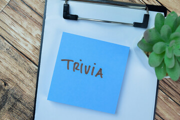 Concept of Trivia write on sticky notes isolated on Wooden Table.