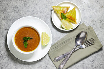 traditional bowl of spiced algerian vegetable soup named (Harira) and meat bourak named bourek