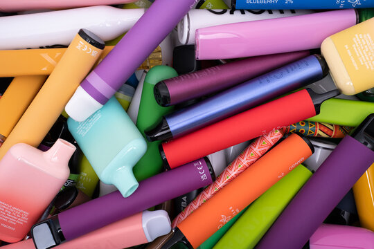 Prague, CZ - 09 August 2023: Synthetic nicotine concepts. Various types of disposable electronic cigarettes. modern alternative smoking, vaping and nicotine. Close up. Editorial
