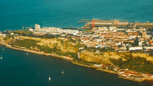 Aerial view of Almada, Christ the King monument, Lisbon, Portugal, River Tagus and urban sprawl, with statue dominating skyline