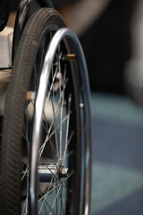 Wheelchair wheel, close-up, copyspace. The concept of inclusion.