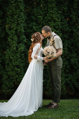 wedding walk of the bride and groom in a coniferous