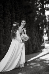 Fototapeta na wymiar wedding walk of the bride and groom in a coniferous