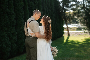 wedding walk of the bride and groom in a coniferous