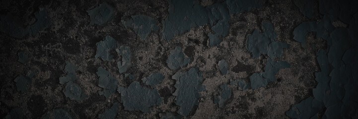 Dark wide panoramic background. Peeling paint on a concrete wall. Dark grunge texture of old cracked flaking paint. Weathered rough painted surface. Patterns of cracks. Darkness background for design.