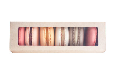 Assorted colorful macarons on cardboard box isolated on white background
