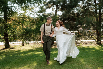 wedding walk of the bride and groom in a coniferous