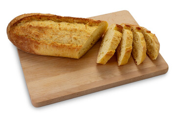 Sliced loaf of durum wheat semolina bread on wooden cutting board isolated