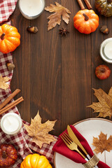 Autumn-themed decor concept. Top view vertical shot of plate, cutlery, napkin, tablecloth,...