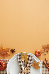Captivating autumnal decor concept. Top view vertical shot of plate, cutlery, napkin, tablecloth,...