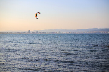 Kiteboarding on the sea at sunset