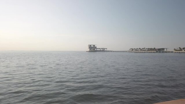 St. Petersburg Vinoy Basin Looking east towards Tampa Bay early morning sun towards pier. Golden hour picture. Blue sky and calm waters.